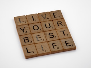 a scrabble tile that says live your best life