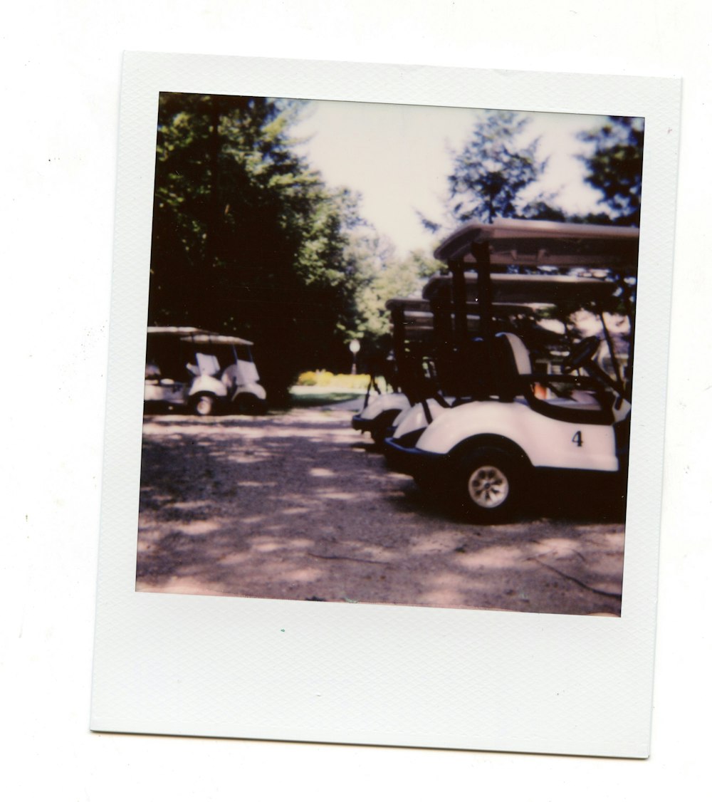 a white and black golf cart parked in a parking lot