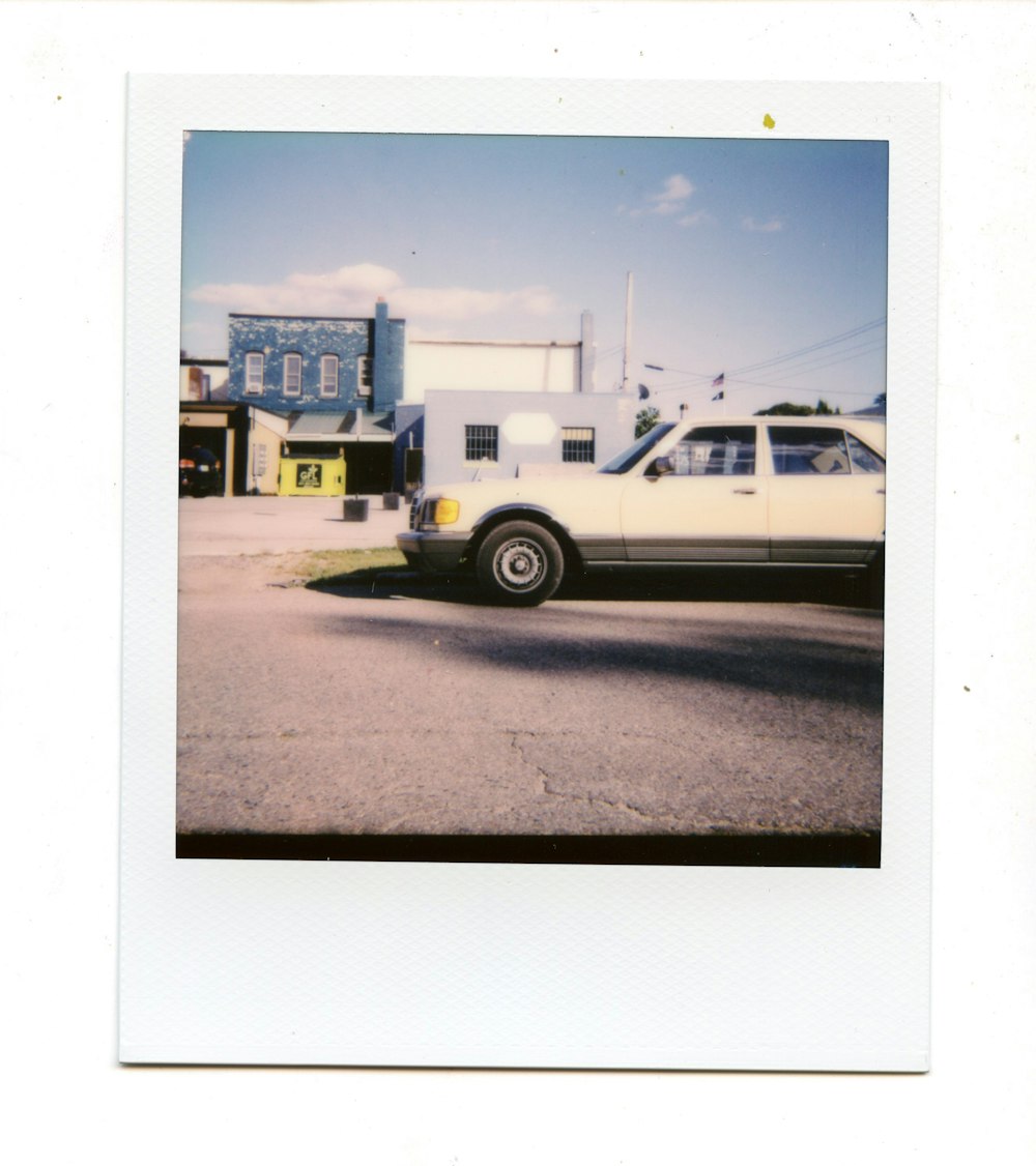 a white car parked in front of a building