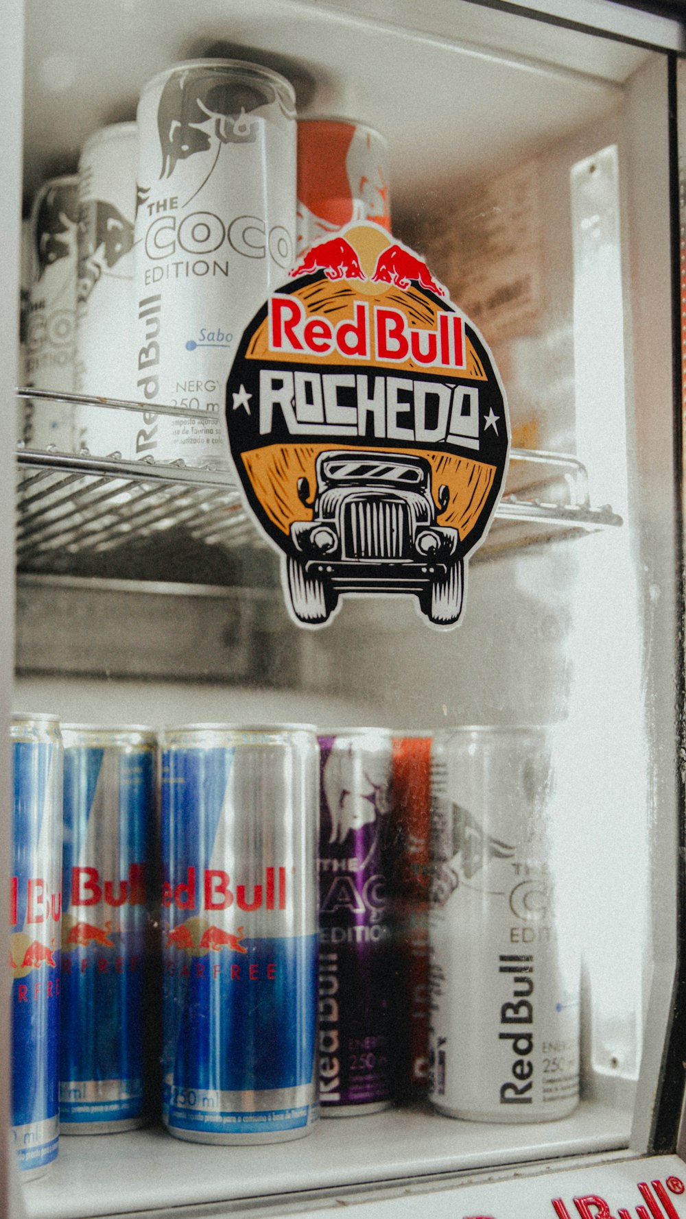 a refrigerator filled with cans and cans of soda