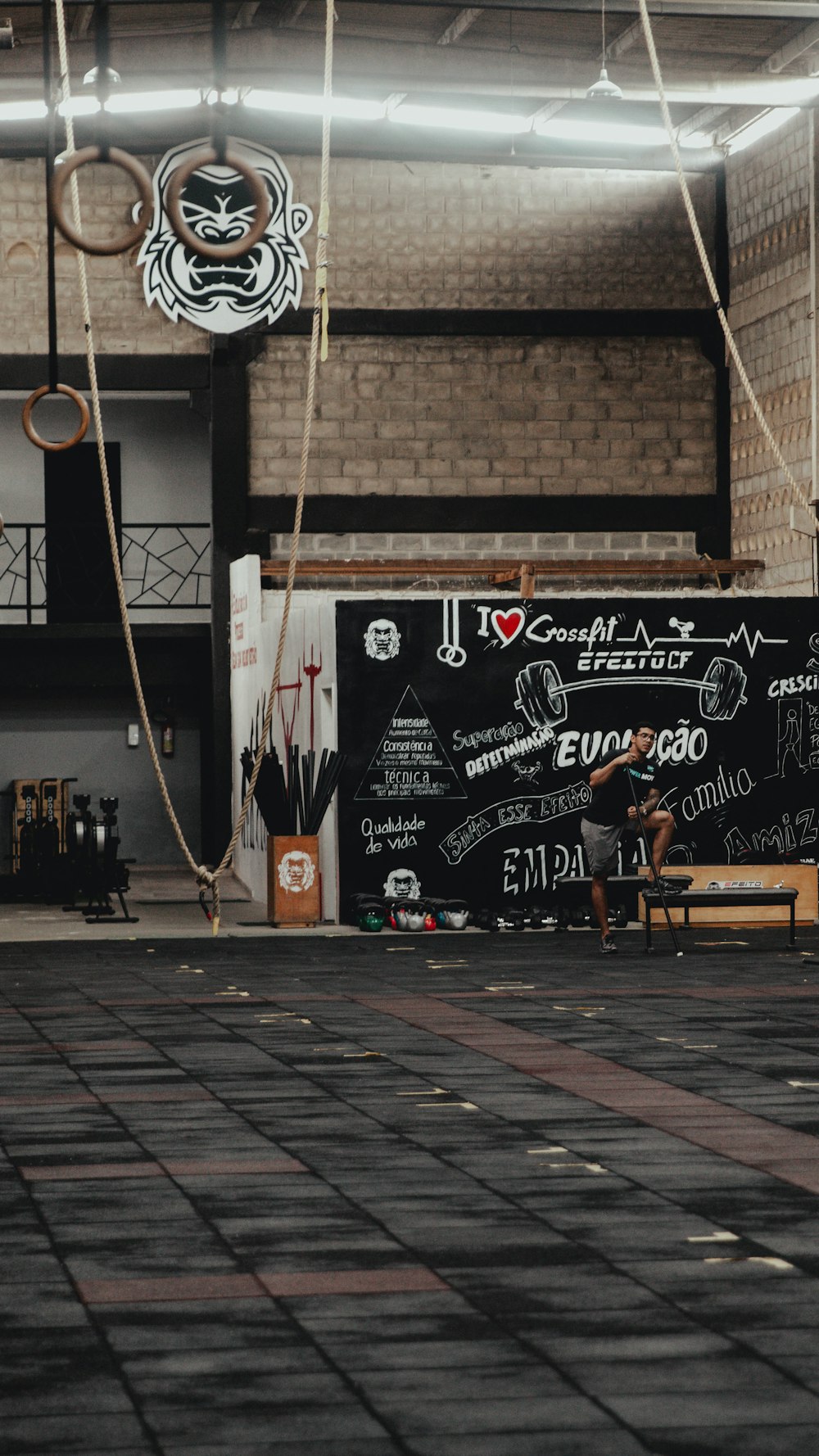 a man sitting on a bench in front of a blackboard