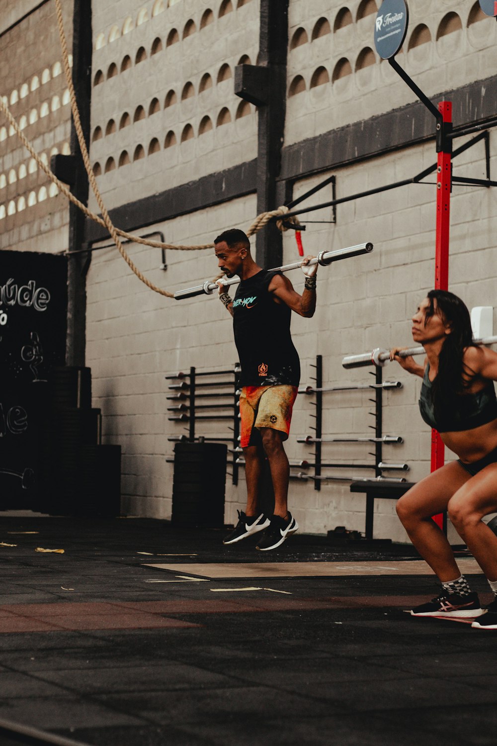 a man holding a rope while standing next to a woman