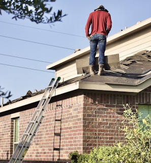 a man standing on the roof of a house