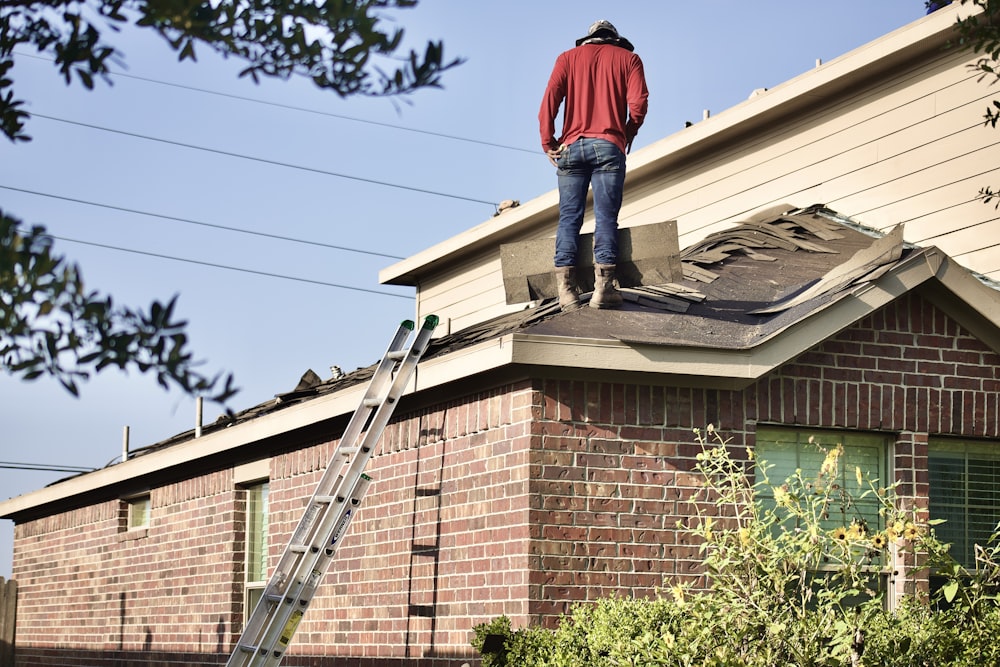 Ein Mann steht auf dem Dach eines Hauses