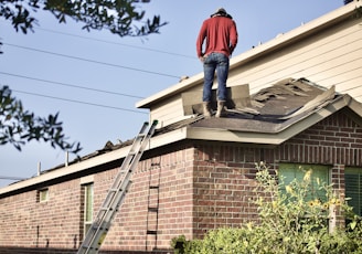 a man standing on the roof of a house