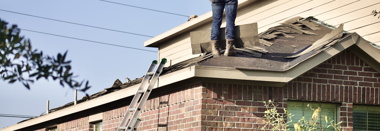 a man standing on the roof of a house