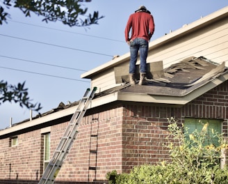 a man standing on the roof of a house