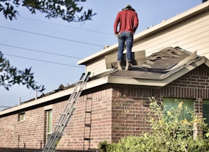 a man standing on the roof of a house