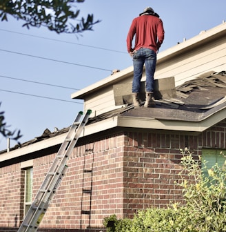 a man standing on the roof of a house