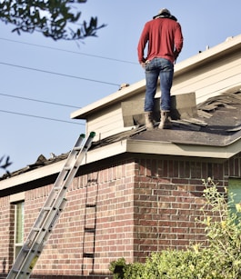 a man standing on the roof of a house