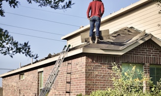 a man standing on the roof of a house