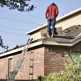 a man standing on the roof of a house