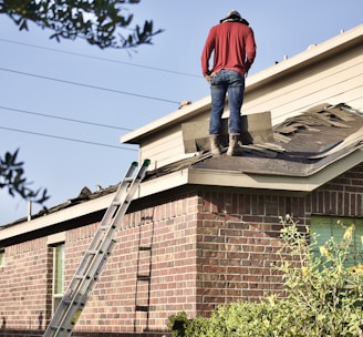 a man standing on the roof of a house