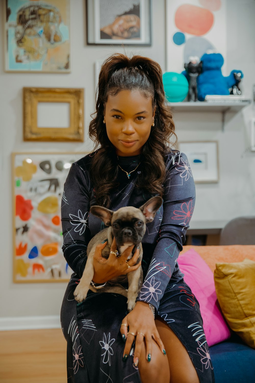 a woman sitting on a couch holding a dog