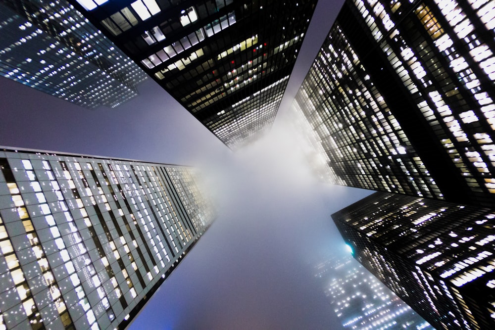 a group of tall buildings with lights on them