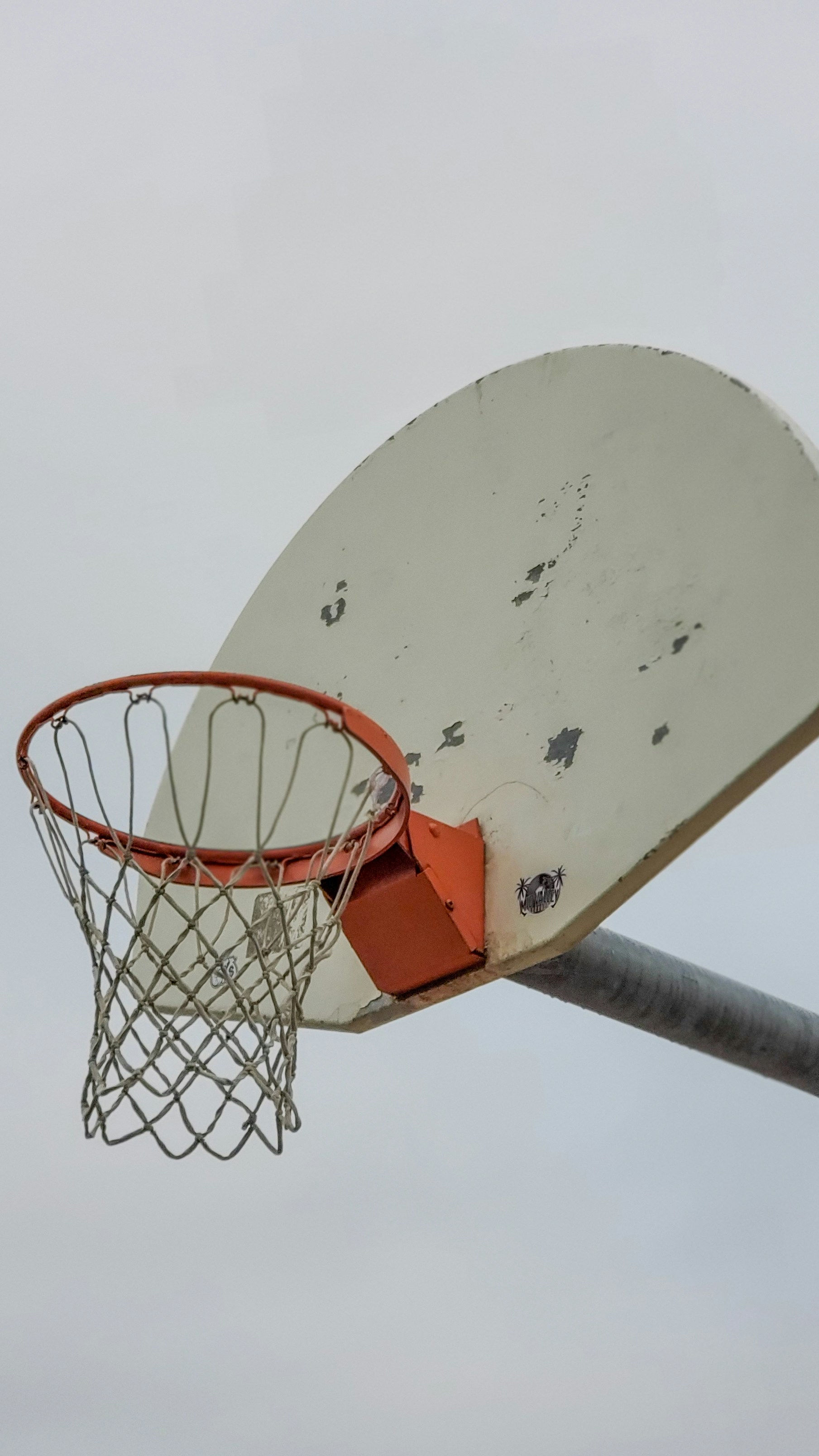 a basketball going through the rim of a basketball hoop
