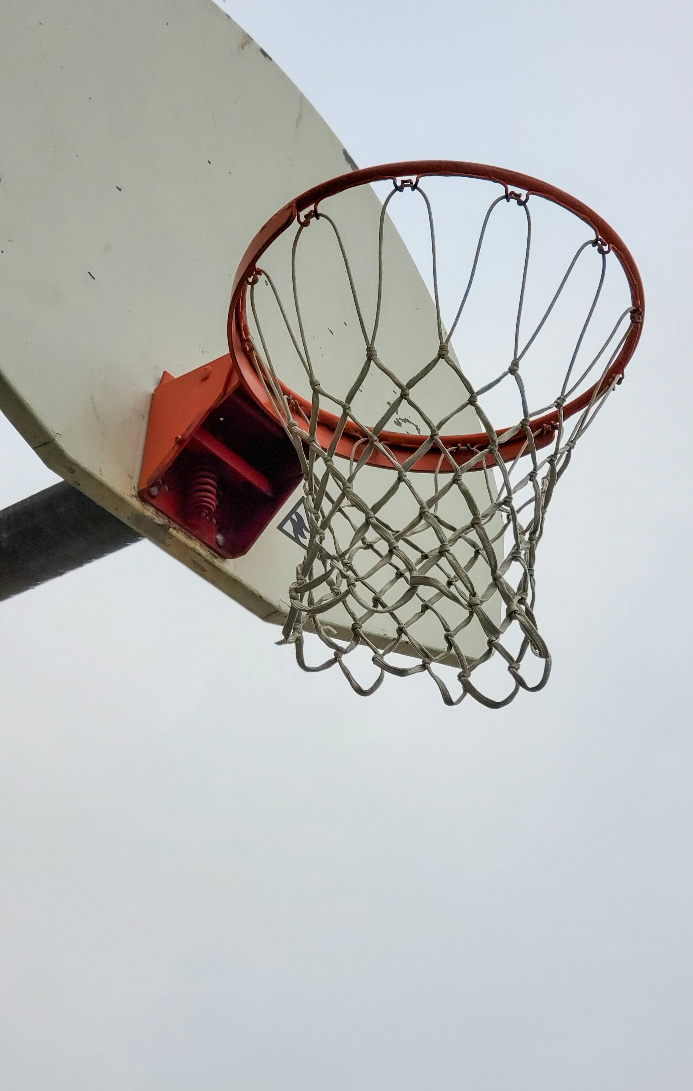 a basketball going through the rim of a basketball hoop