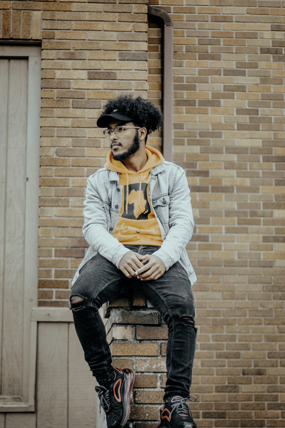 a man sitting on top of a brick building