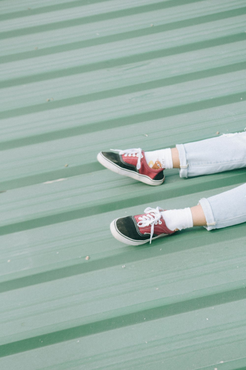 a person laying on top of a metal roof