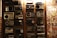A collection of vintage radios displayed on a wooden wall, each with distinct designs and dials. To the right, an assortment of old album covers is arranged in a grid pattern.