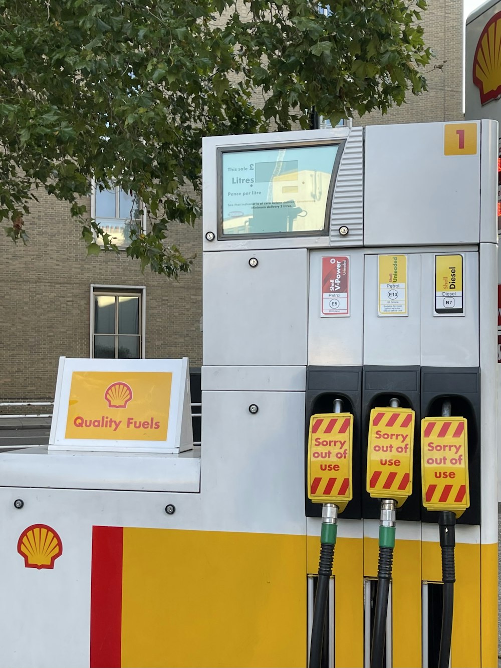 a shell gas station with three gas pumps