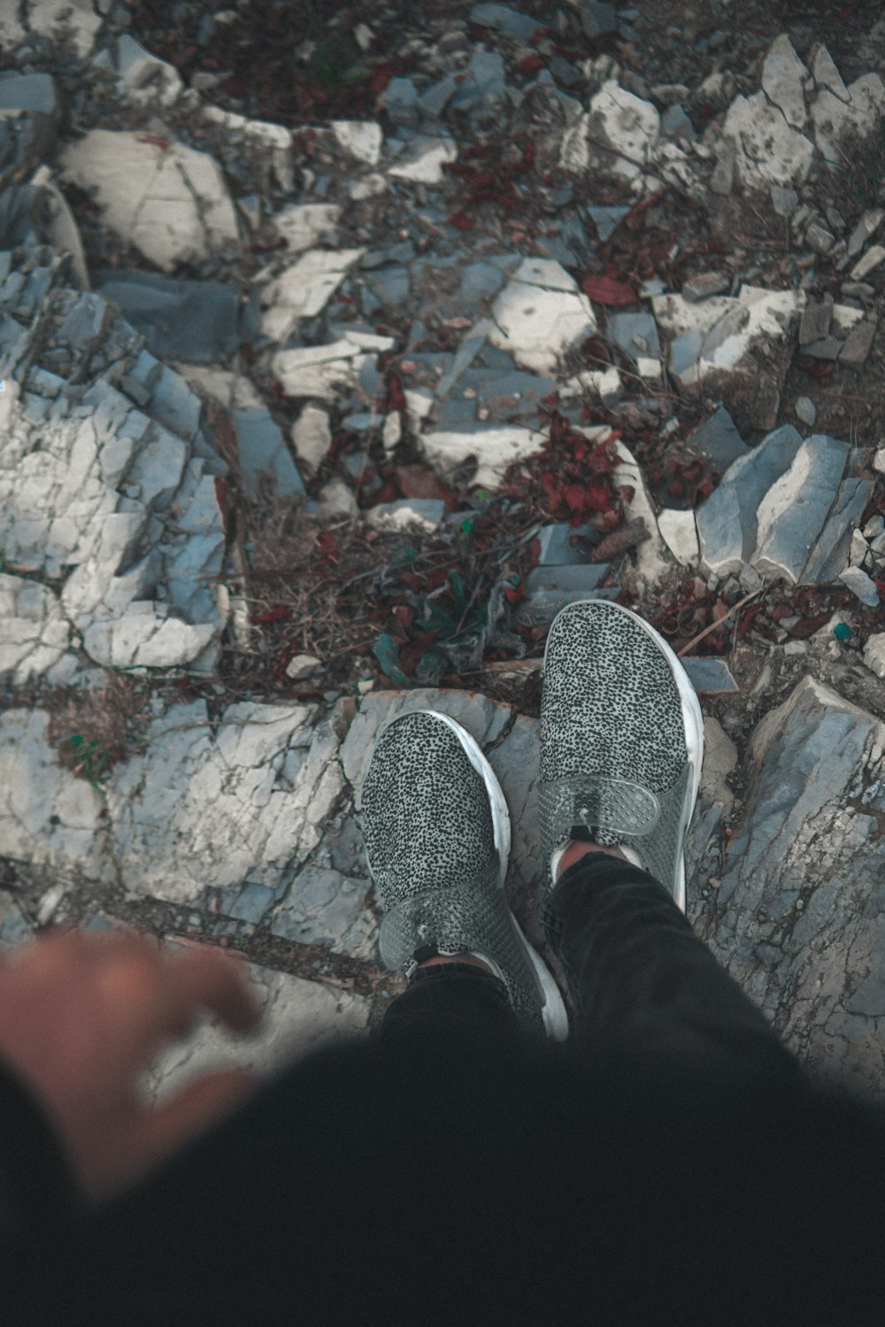 a person standing on top of a pile of rocks