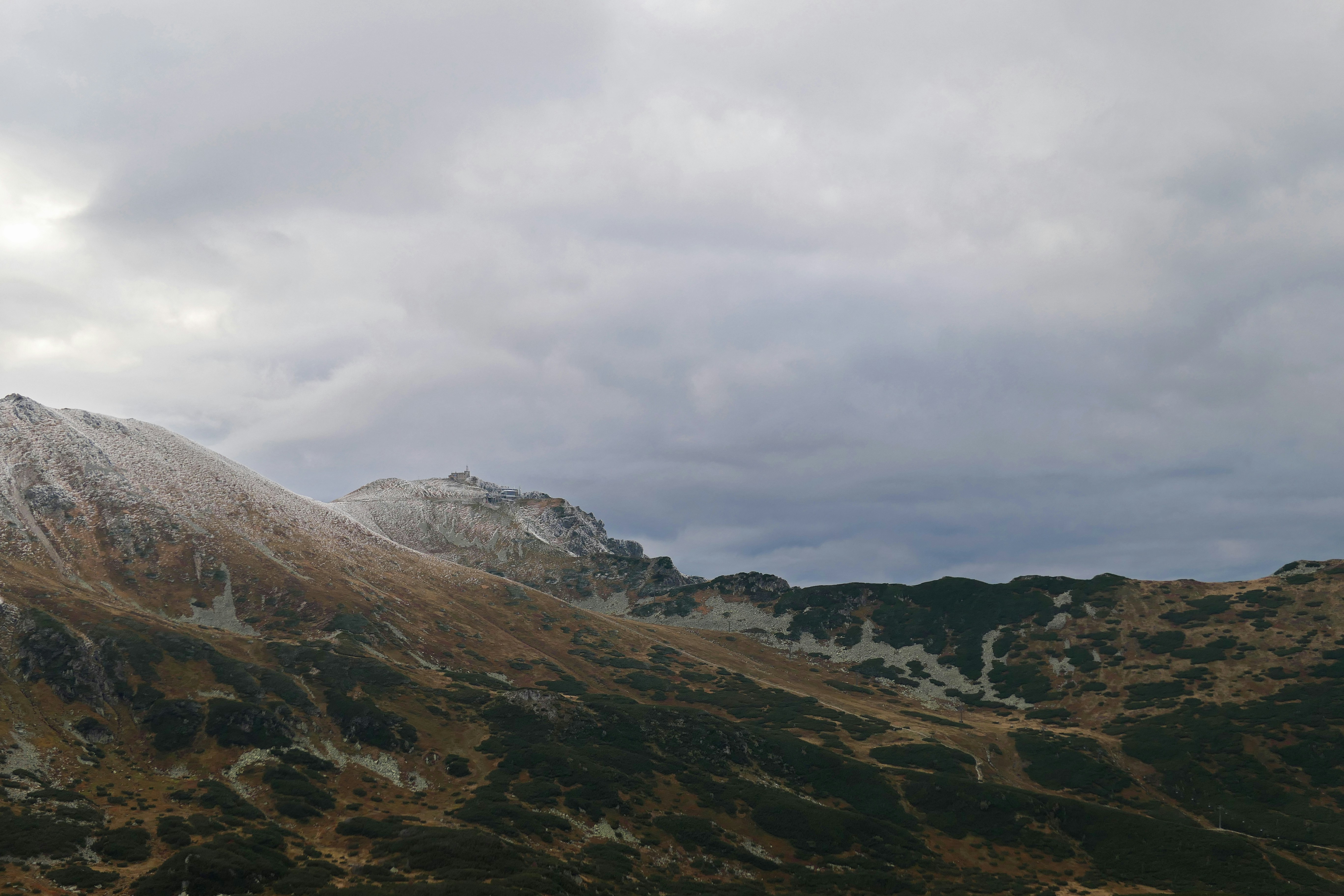 a view of a mountain range with a cloudy sky