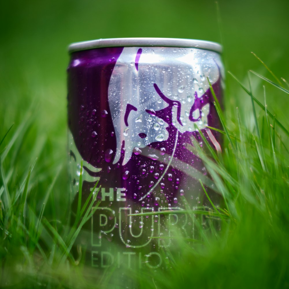 a can of beer sitting in the grass