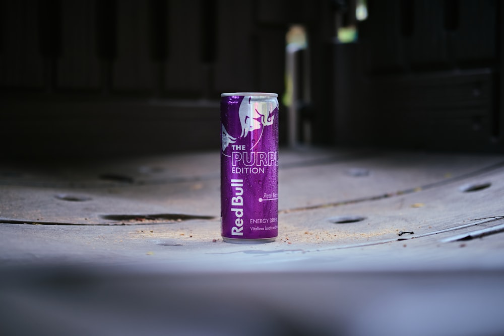 a can of energy drink sitting on the ground