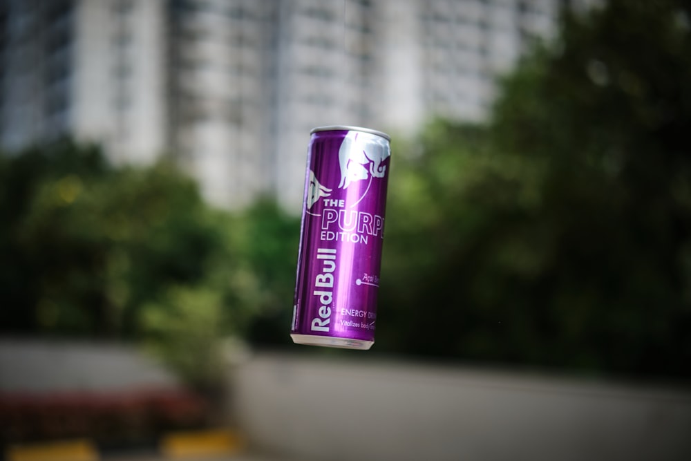 a can of energy drink hanging in the air