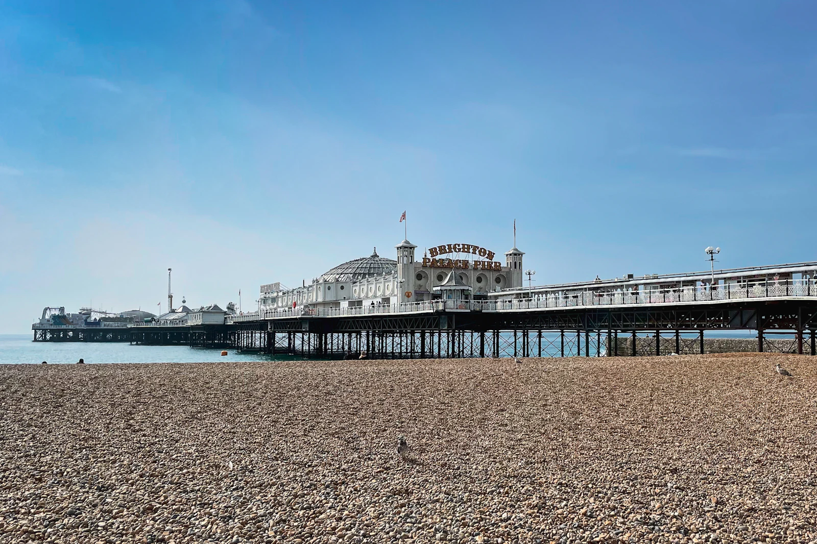 Brighton pier and beach under a blue sky