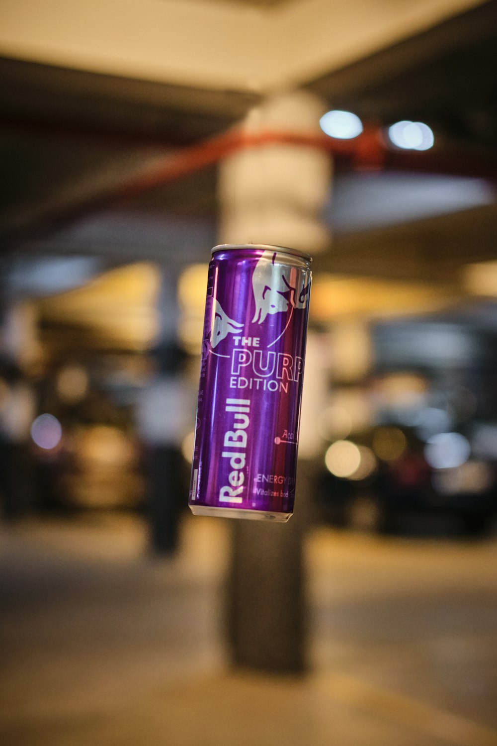 a can of beer hanging from a pole