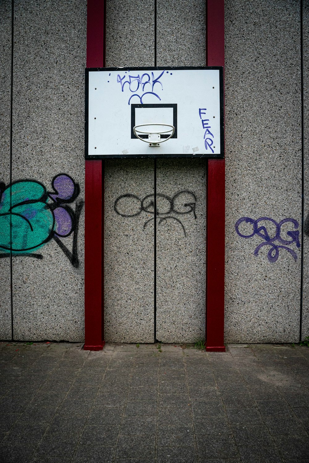 a basketball court with graffiti on the side of it