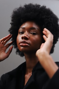 a woman with an afro combing her hair