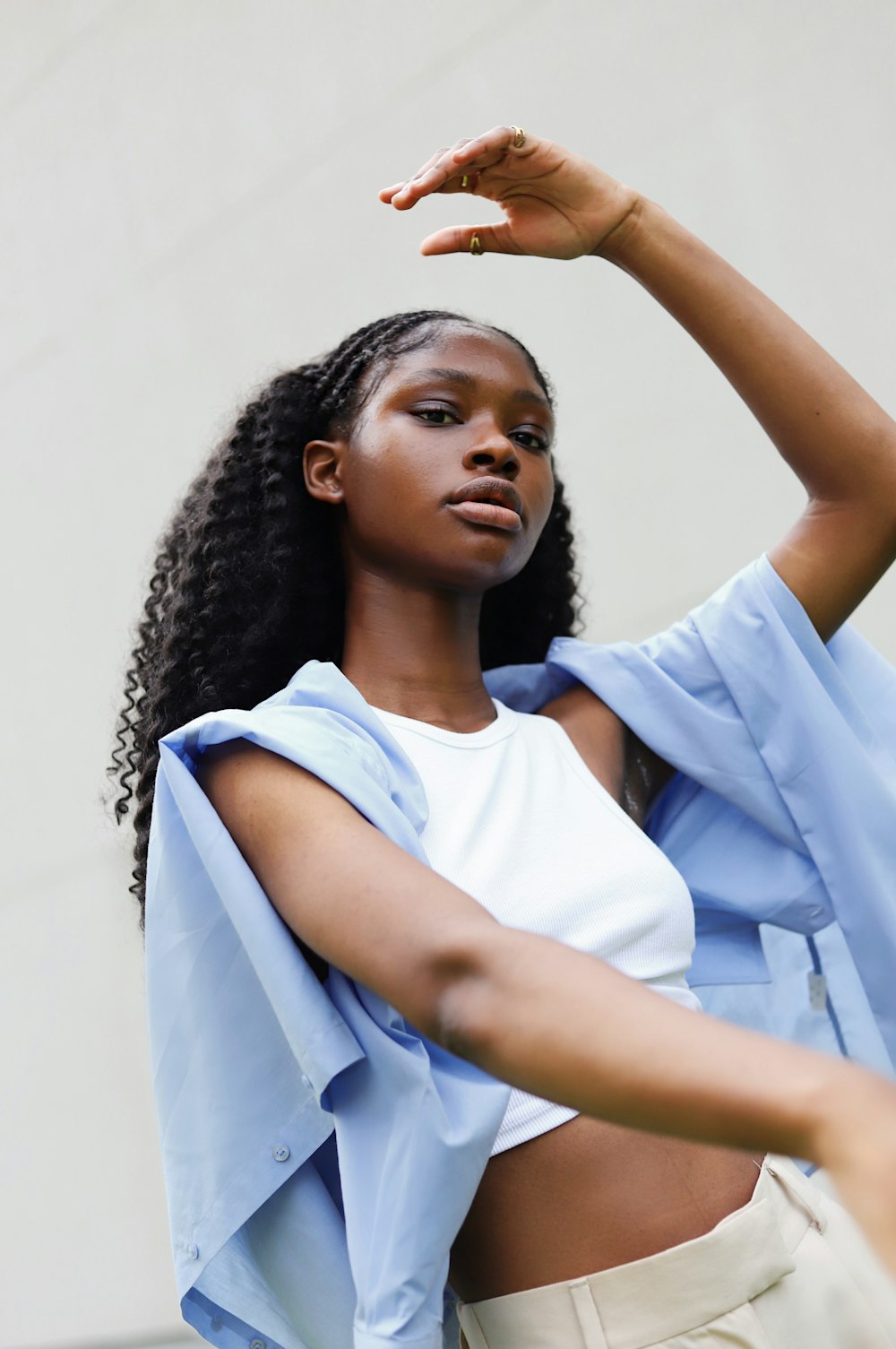 a woman in a white top and a blue jacket