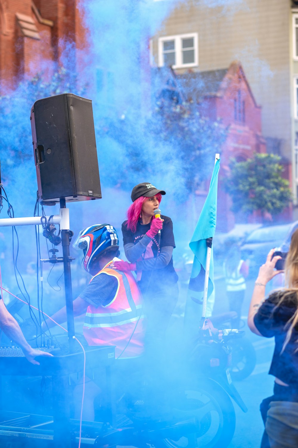 a person on a motorcycle with blue smoke coming out of it