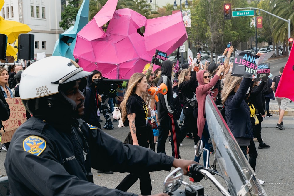 a police officer on a motorcycle holding a sign