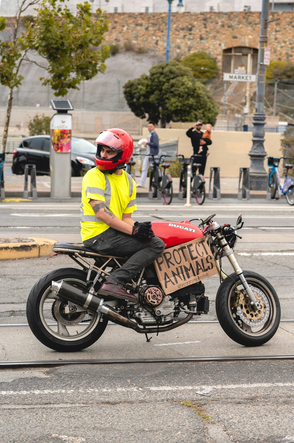 a man on a motorcycle with a sign on the back