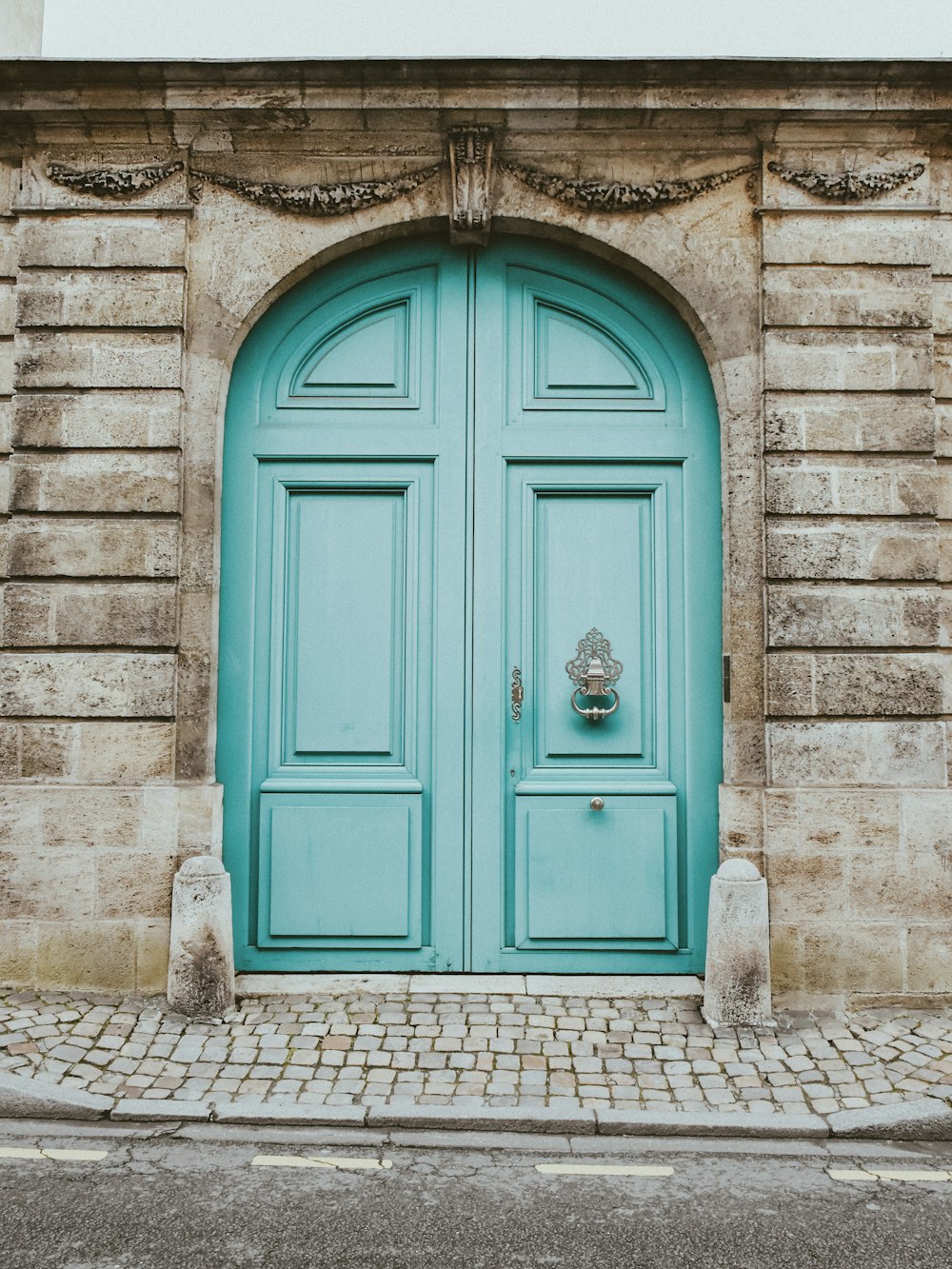 a blue door with a clock on the side of it