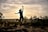 a person jumping in the air with their arms in the air