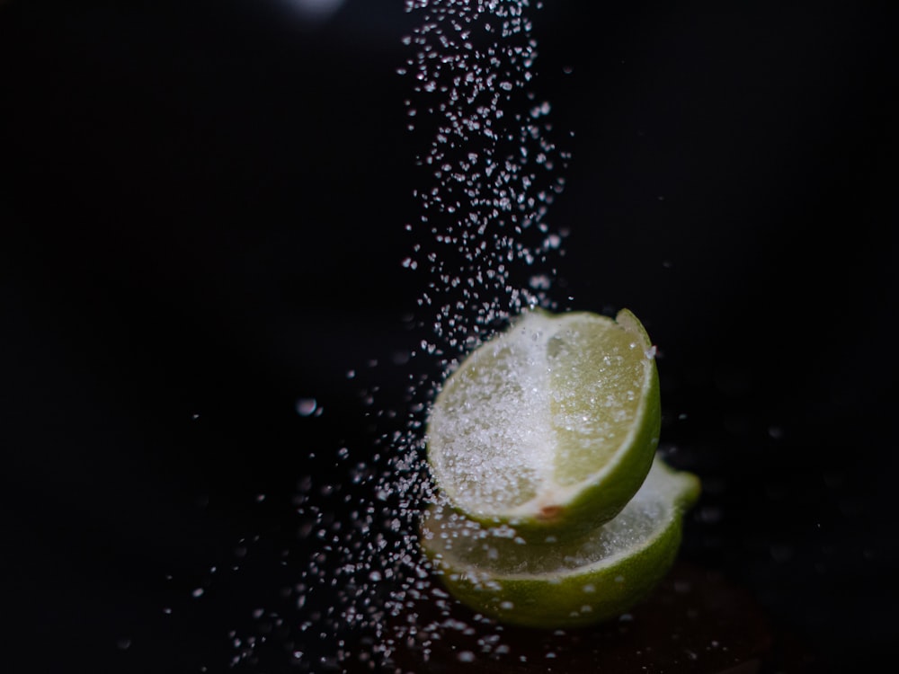 a slice of lime being sprinkled with sugar