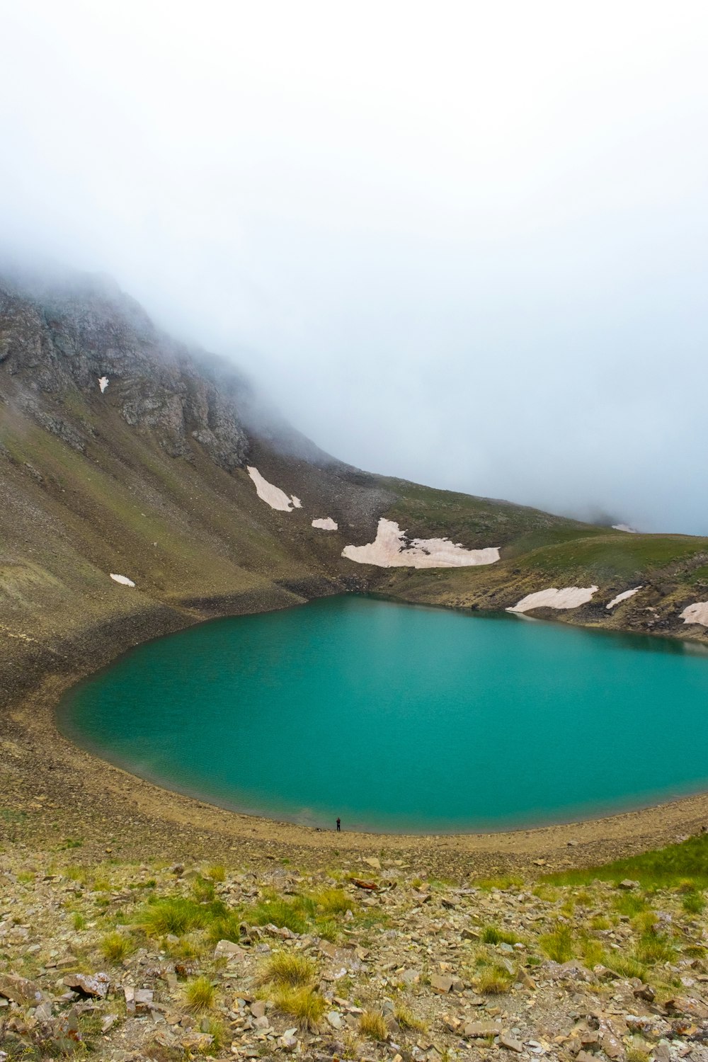 a large blue lake surrounded by a mountain