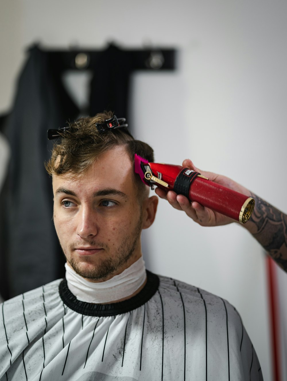 a man getting his hair cut at a barber shop