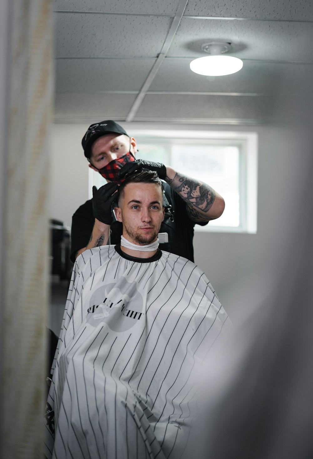 a man getting his hair cut in a barber shop