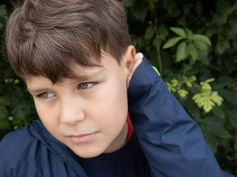 a close up of a child wearing a blue jacket
