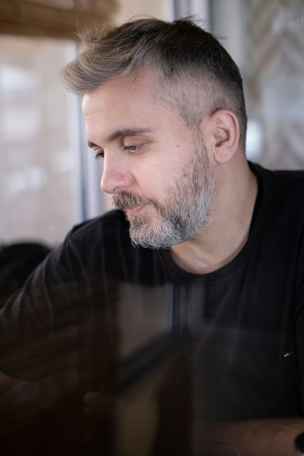 a man sitting at a table looking at his cell phone