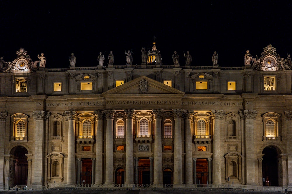 a large building lit up at night with lights on