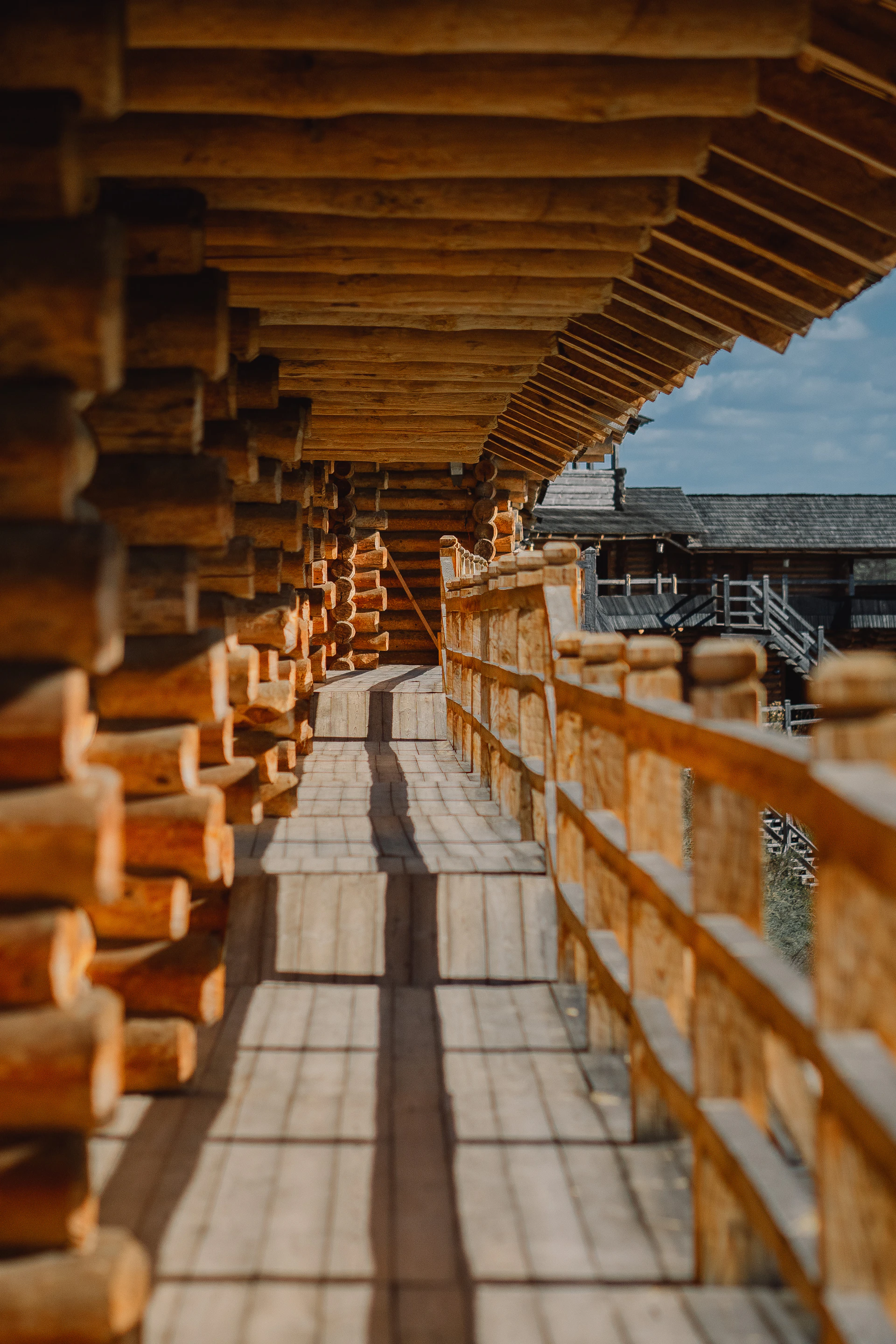 a walkway lined with wooden planks next to a building