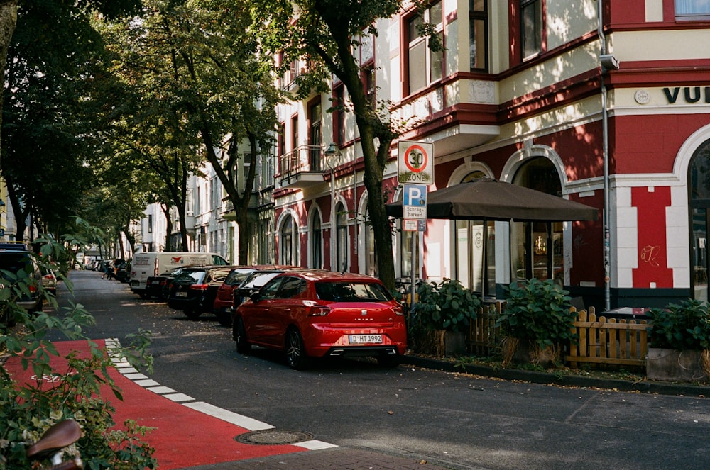 a row of parked cars sitting on the side of a road