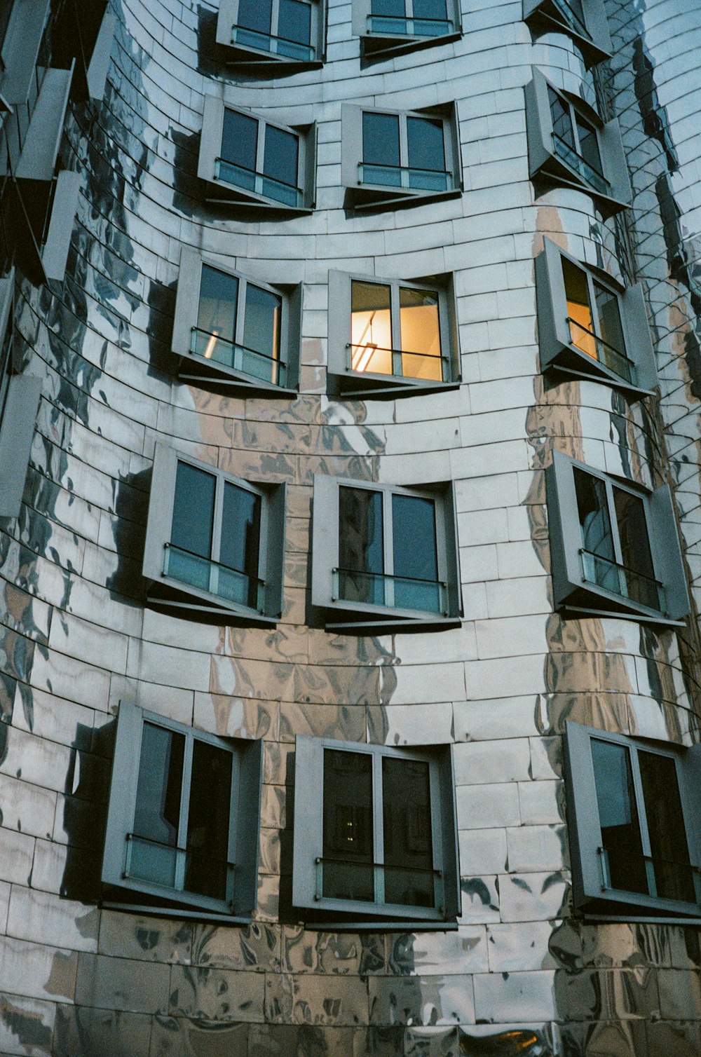 a very tall building with many windows and a clock